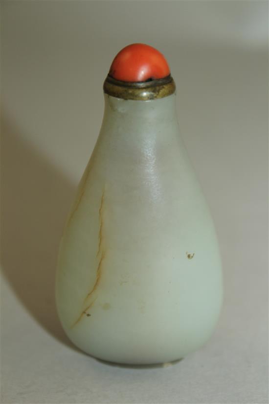 A Chinese pale celadon jade pear shaped snuff bottle, 1750-1850, 6cm, brass and coral stopper